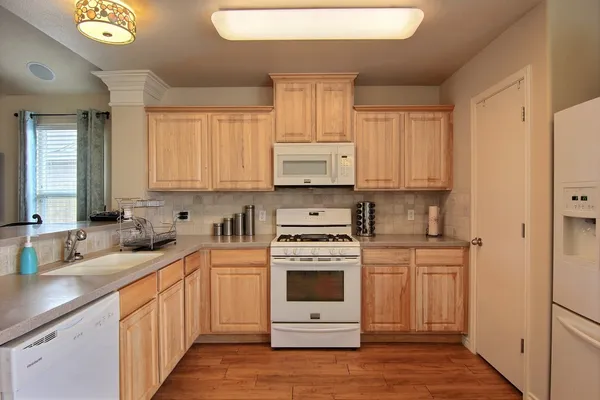 a kitchen with a white cabinets and white appliances