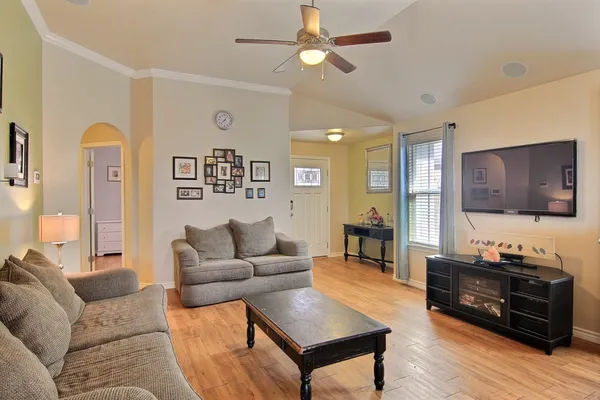 a living room with furniture and wooden floor