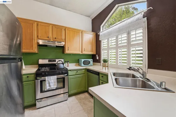 a kitchen that has a sink and a stove