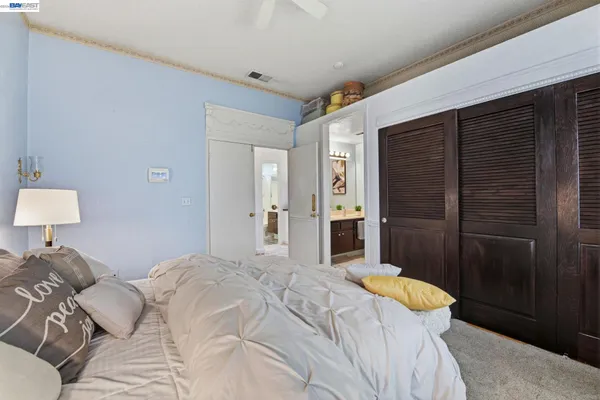 a bedroom with a bed and a lamp