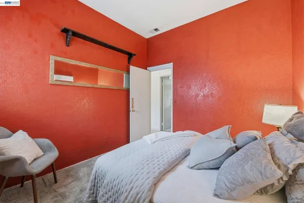 a bedroom with a bed and a chair