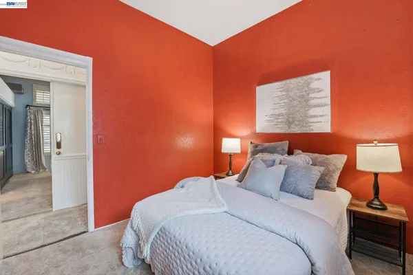 a bedroom with a bed and a lamp