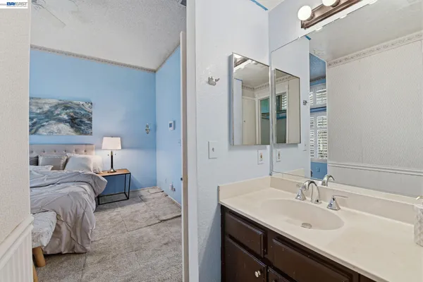 a en suite bathroom with a double vanity sink and a mirror