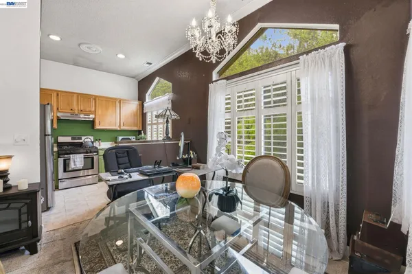 a living room with fireplace furniture and a chandelier