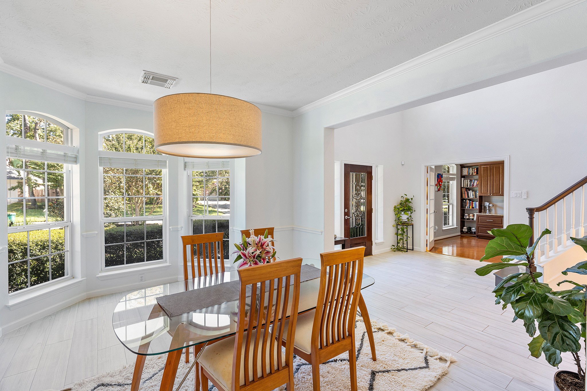 30 South Dulcet Hollow Circle Spring, TX 77382 - Photo 13 of 36 a view of a dining room with furniture large windows and wooden floor