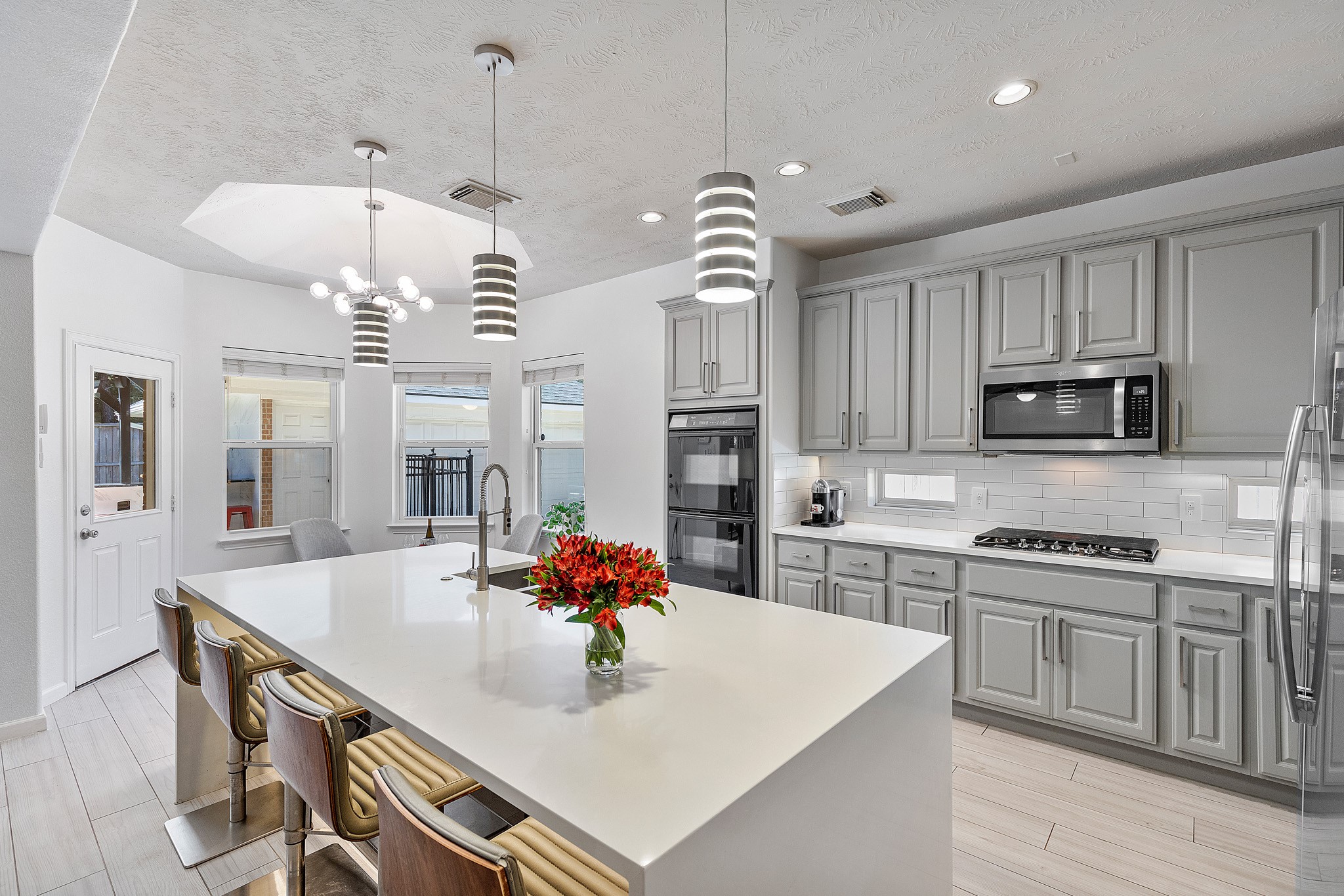 30 South Dulcet Hollow Circle Spring, TX 77382 - Photo 14 of 36 a large kitchen with kitchen island a stove a sink a dining table and chairs