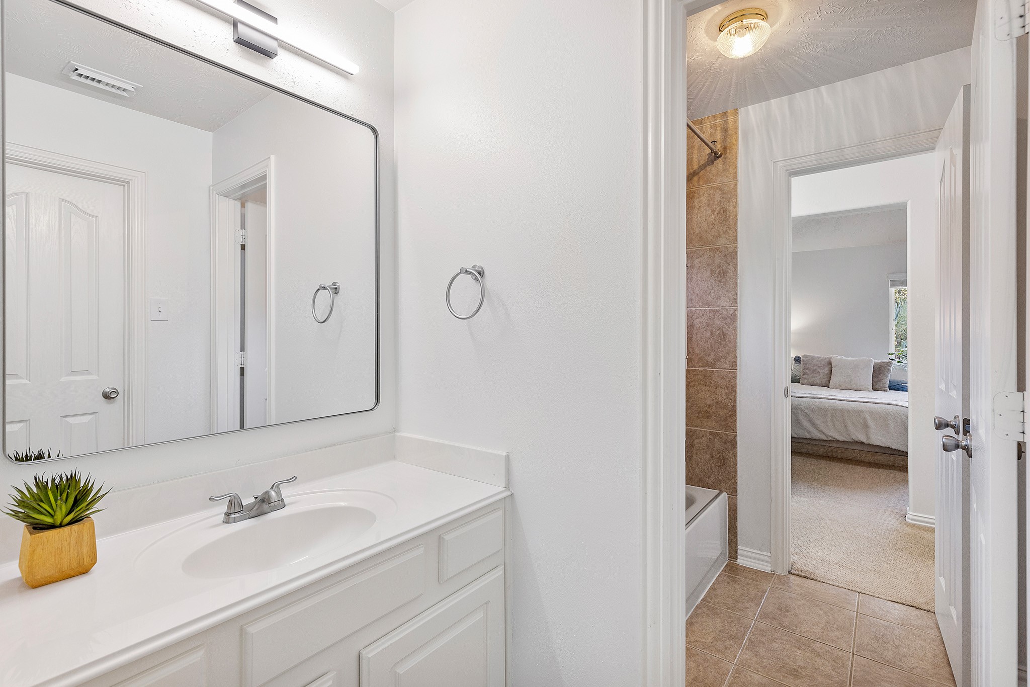30 South Dulcet Hollow Circle Spring, TX 77382 - Photo 32 of 36 a en suite bathroom with a sink a mirror and a shower
