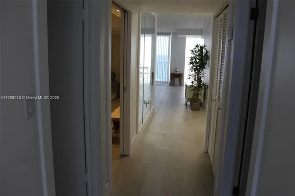 a view of a hallway with wooden shelves