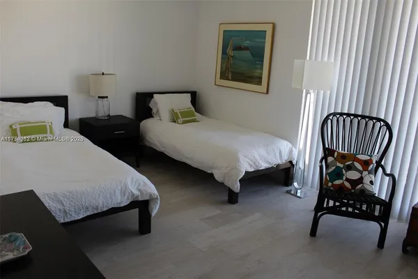 a bedroom with bed and a window