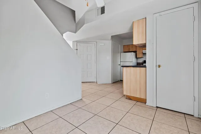 a view of a kitchen with wooden cabinets and a stove top oven