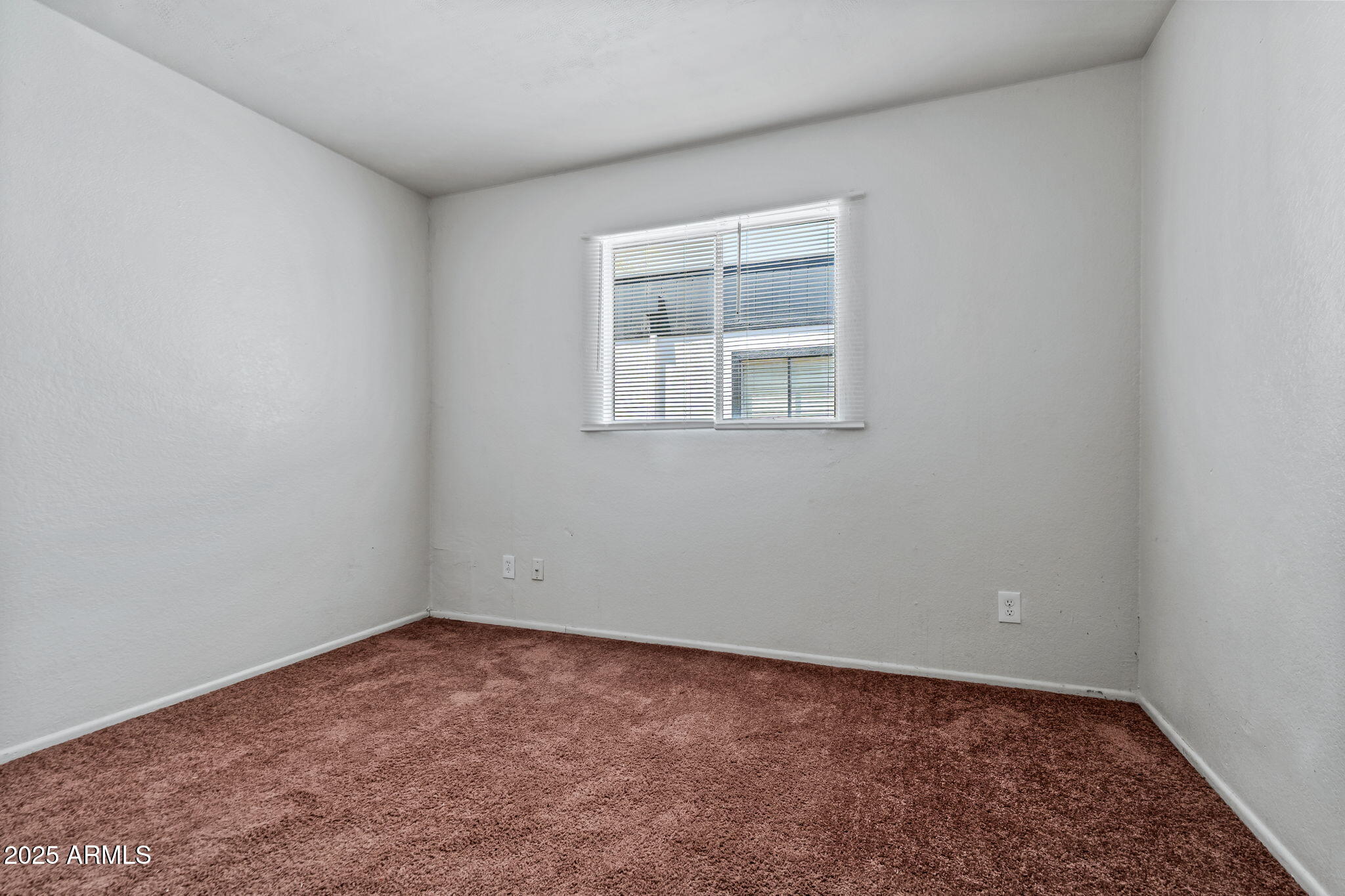 1742 East Pepper Circle, Unit 2 Mesa, AZ 85203 - Photo 15 of 26 an empty room with a window
