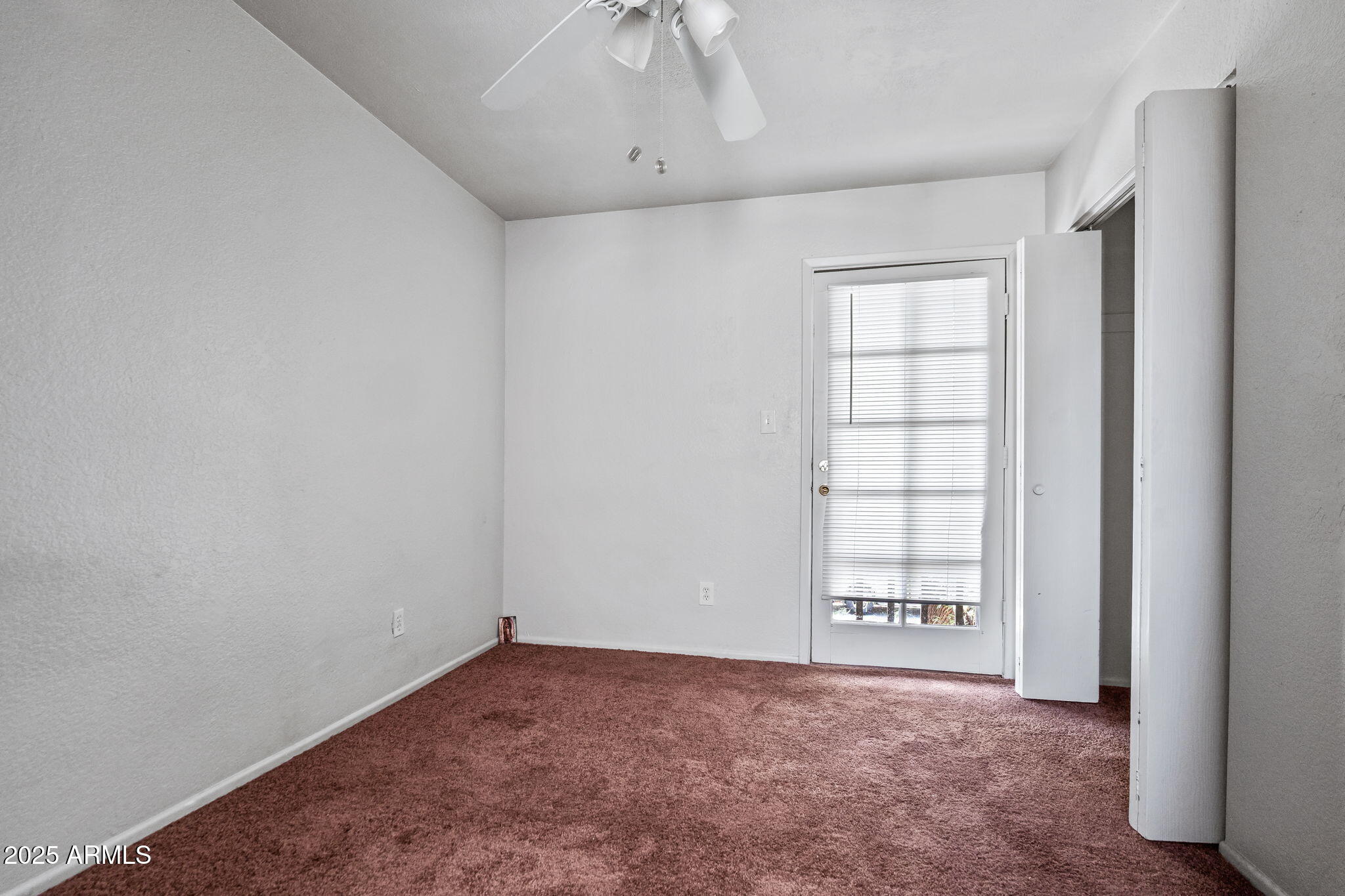 1742 East Pepper Circle, Unit 2 Mesa, AZ 85203 - Photo 18 of 26 an empty room with windows and closet