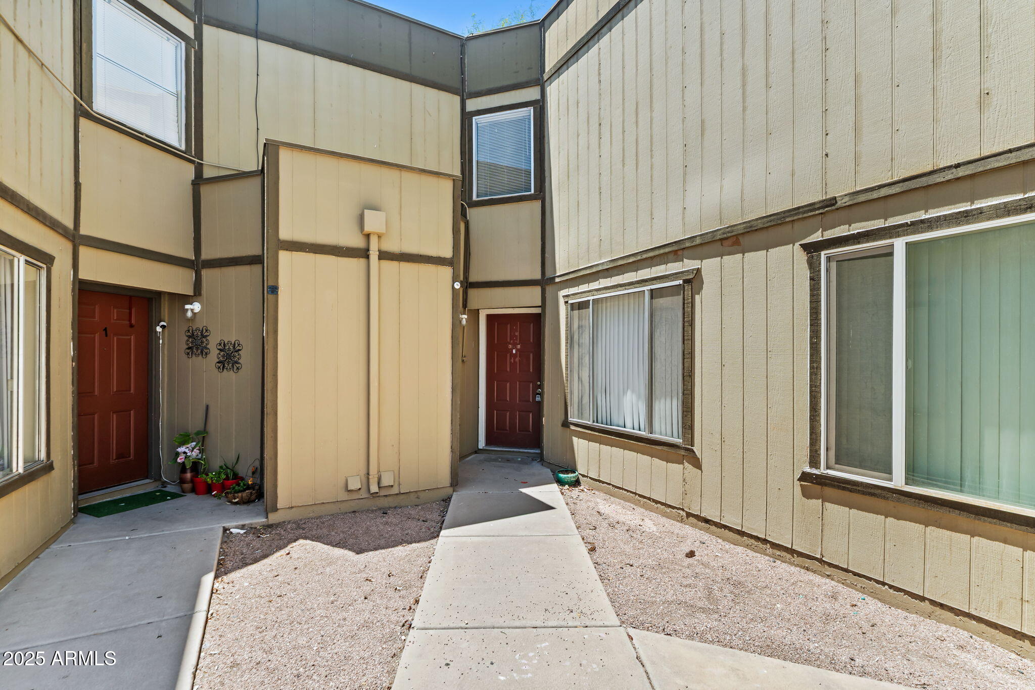 1742 East Pepper Circle, Unit 2 Mesa, AZ 85203 - Photo 2 of 26 a view of a house with a outdoor space