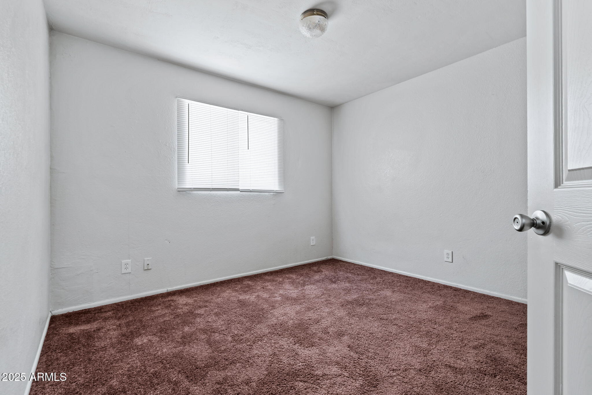 1742 East Pepper Circle, Unit 2 Mesa, AZ 85203 - Photo 22 of 26 an empty room with a window