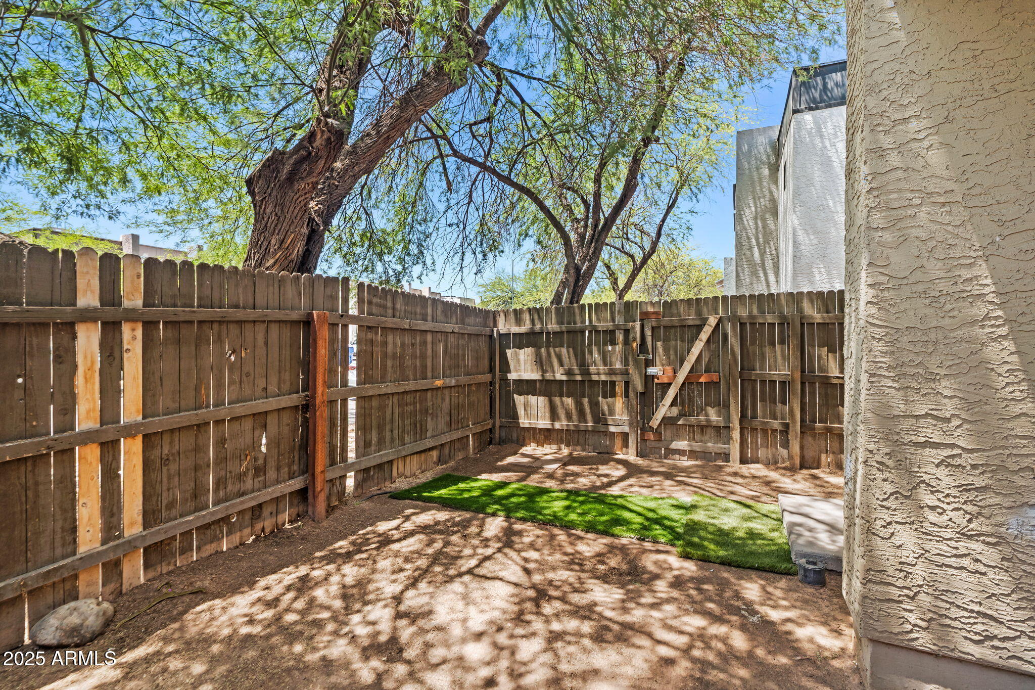 1742 East Pepper Circle, Unit 2 Mesa, AZ 85203 - Photo 24 of 26 a view of a backyard with a small cabin and a chair