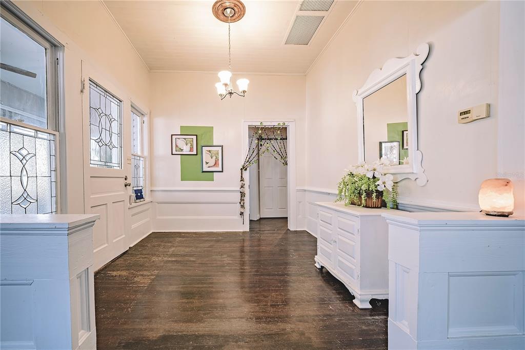 510 East Key Avenue Eustis, FL 32726 - Photo 11 of 40 a view of an entryway with wooden floor and a living room