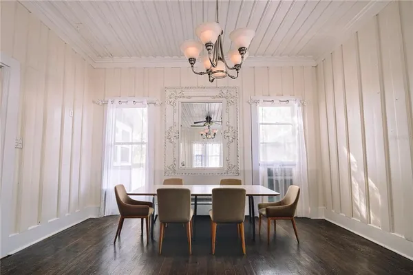 a view of a dining room with furniture windows and wooden floor