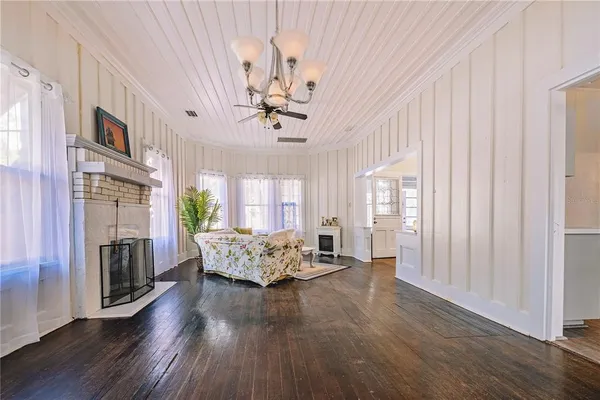 a living room with furniture fireplace and chandelier