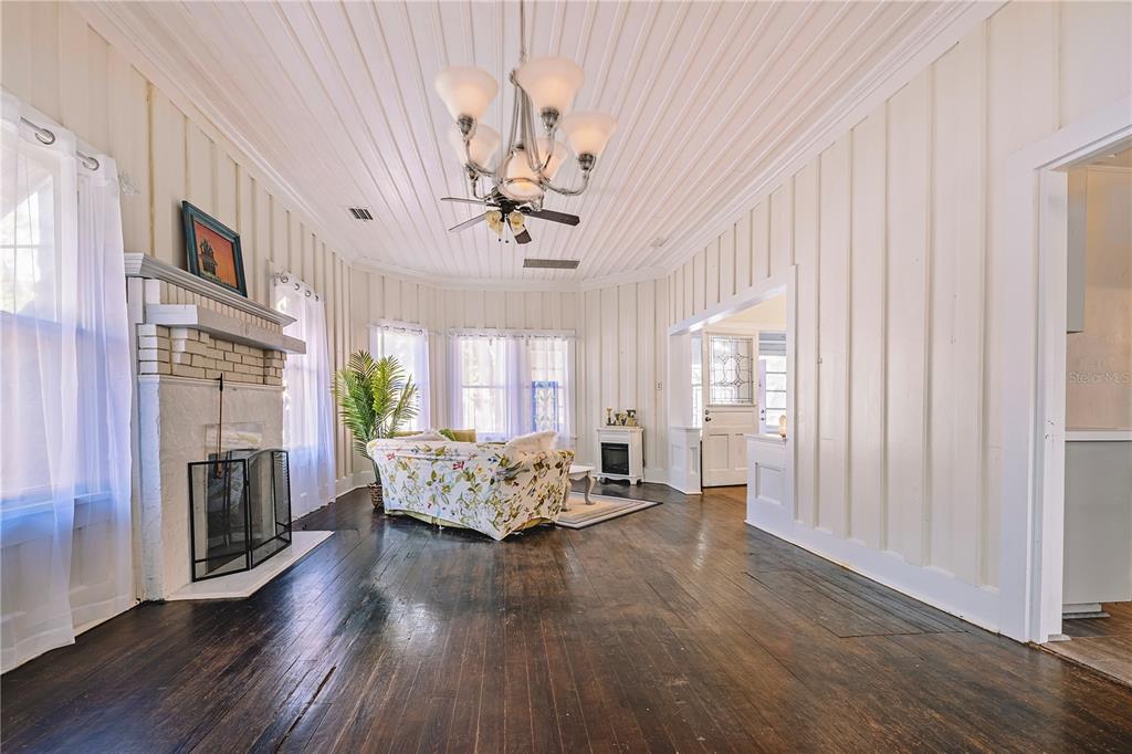510 East Key Avenue Eustis, FL 32726 - Photo 15 of 40 a living room with furniture fireplace and chandelier