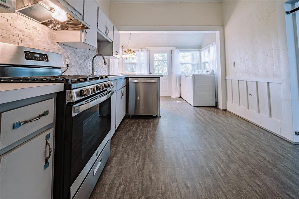 510 East Key Avenue Eustis, FL 32726 - Photo 20 of 40 a kitchen with stainless steel appliances granite countertop a stove cabinets and wooden floor