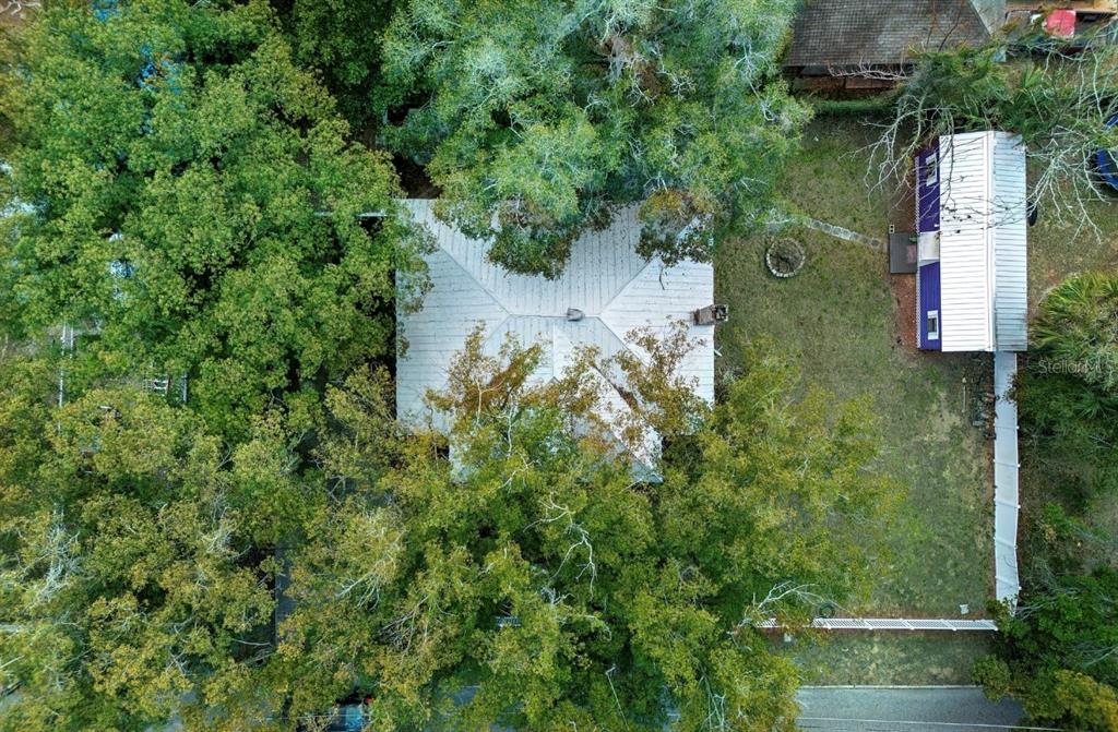 510 East Key Avenue Eustis, FL 32726 - Photo 5 of 40 an aerial view of a house with a yard and large trees