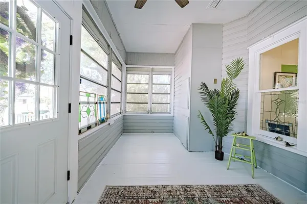 a room with a potted plant and a large window