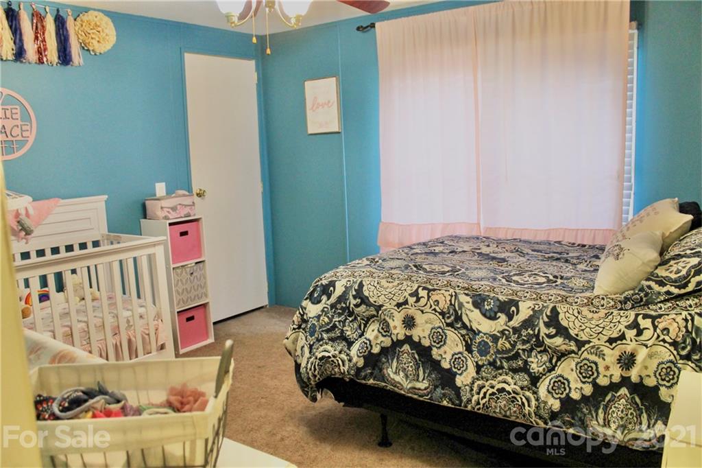 199 Robertson Road Rutherfordton, NC 28139 - Photo 11 of 13 a bedroom with a bed and a window
