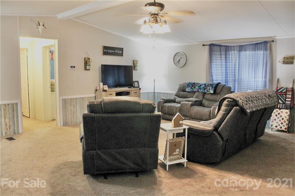199 Robertson Road Rutherfordton, NC 28139 - Photo 4 of 13 a living room with furniture a flat screen tv and a window