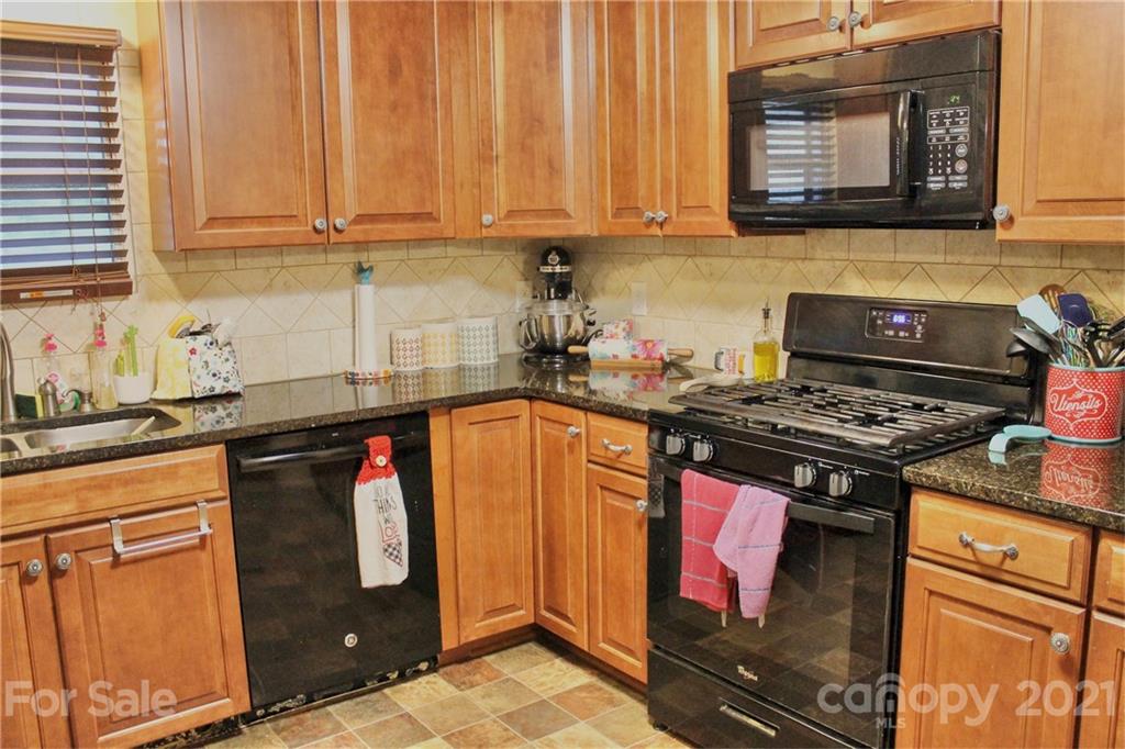 199 Robertson Road Rutherfordton, NC 28139 - Photo 6 of 13 a kitchen with stainless steel appliances granite countertop a stove and a microwave