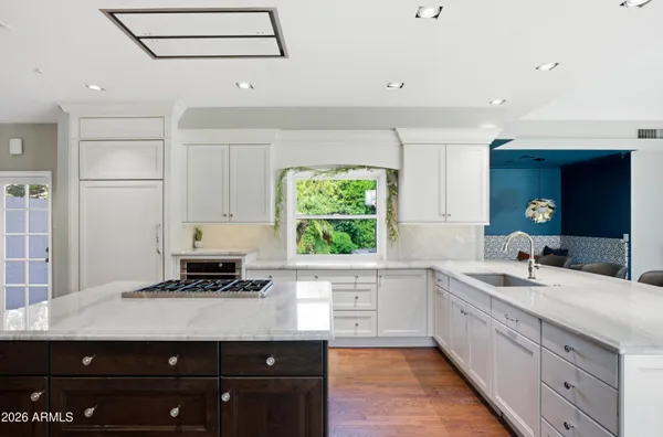 a kitchen with a sink window and cabinets