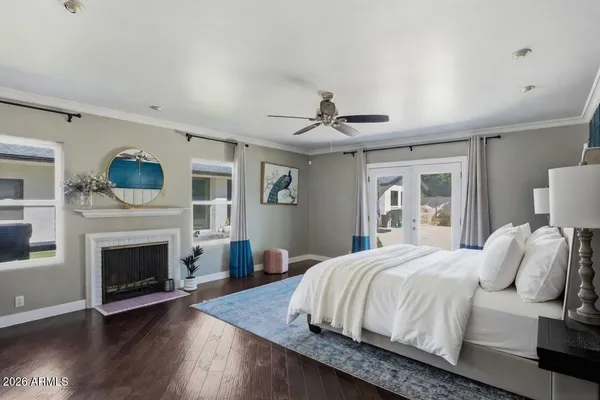 a bedroom with a large bed and a fireplace