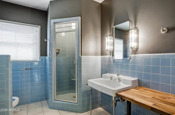 a bathroom with a sink a shower and a mirror