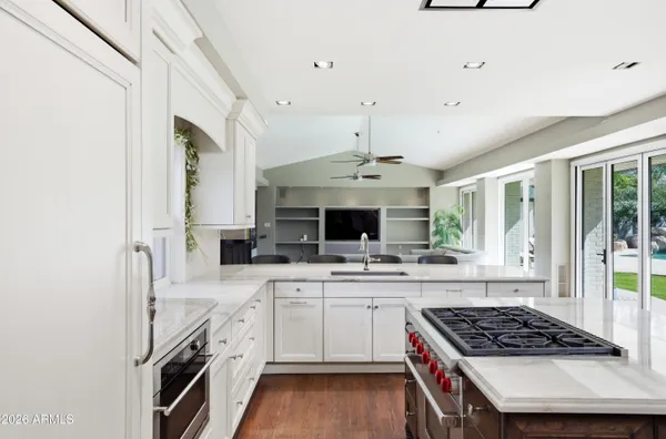 a kitchen with stainless steel appliances a sink stove and cabinets