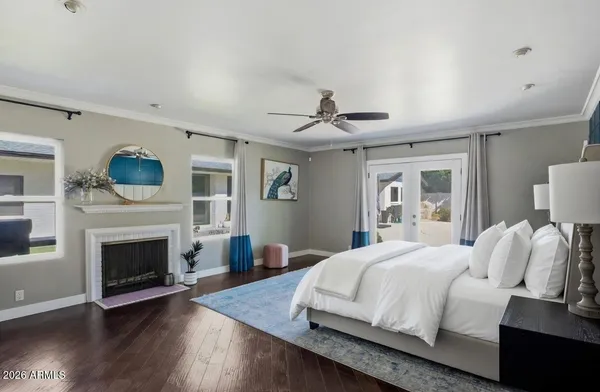 a bedroom with a large bed and a fireplace