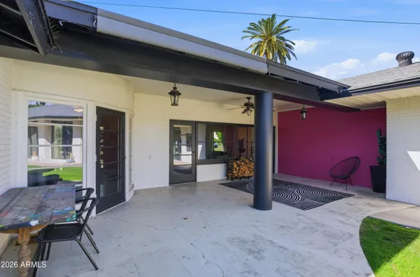 a view of a house with a yard and potted plants