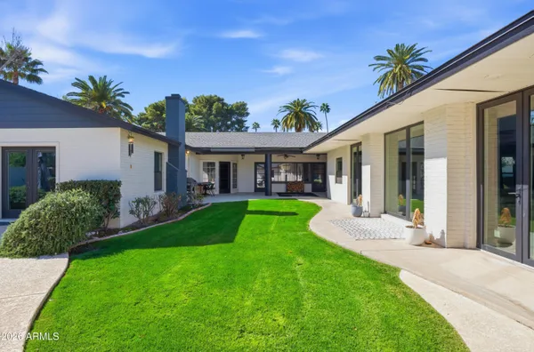 a front view of a house with a yard table and chairs