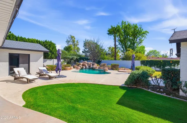 a view of a house with swimming pool and sitting area