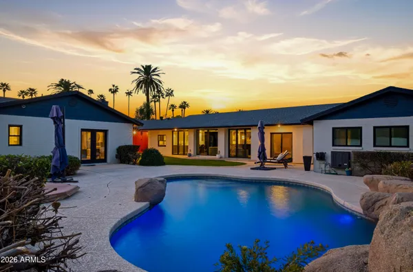 a view of a house with a backyard porch and sitting area
