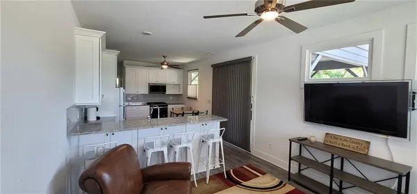 a bathroom with a granite countertop sink a window and a mirror