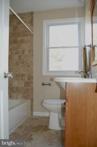 839 Reverdy Road Baltimore, MD 21212 - Photo 3 of 16 a bathroom with a toilet sink and a shower