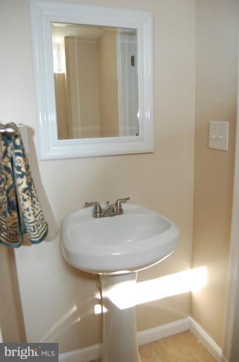 839 Reverdy Road Baltimore, MD 21212 - Photo 5 of 16 a bathroom with a sink and a mirror