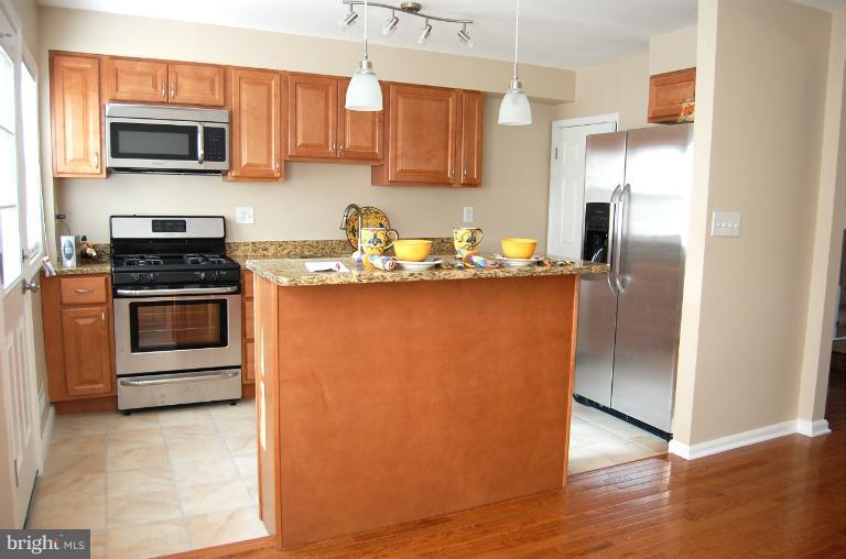 839 Reverdy Road Baltimore, MD 21212 - Photo 6 of 16 a kitchen with a sink stove and microwave