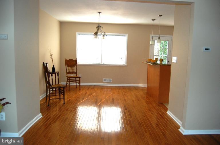 839 Reverdy Road Baltimore, MD 21212 - Photo 7 of 16 wooden floor in an empty room with a window