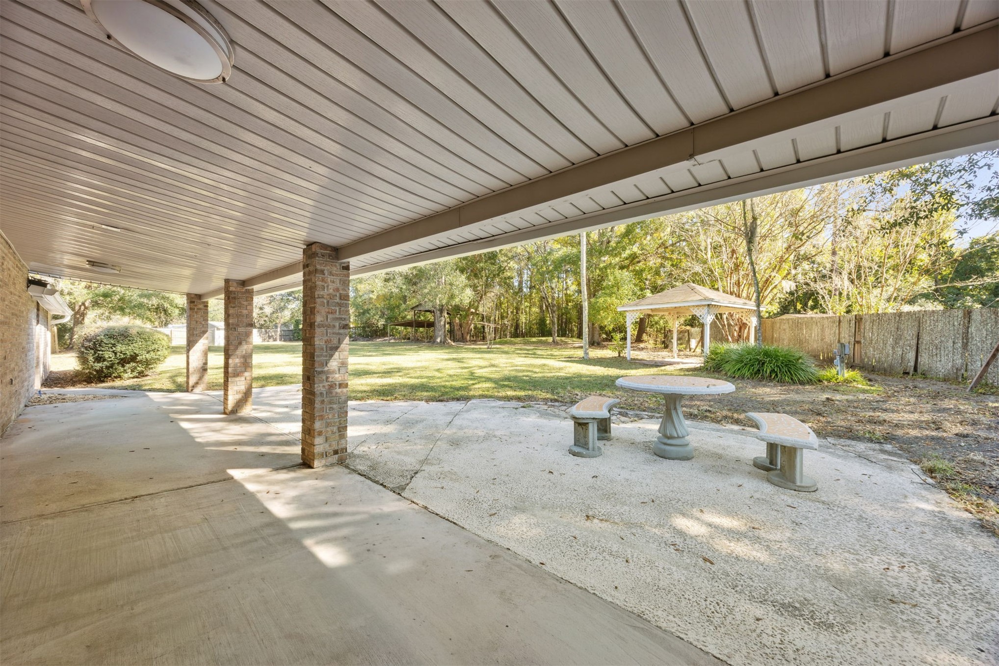44186 Lee Drive Callahan, FL 32011 - Photo 21 of 29 a view of a patio with table and chairs next to a yard