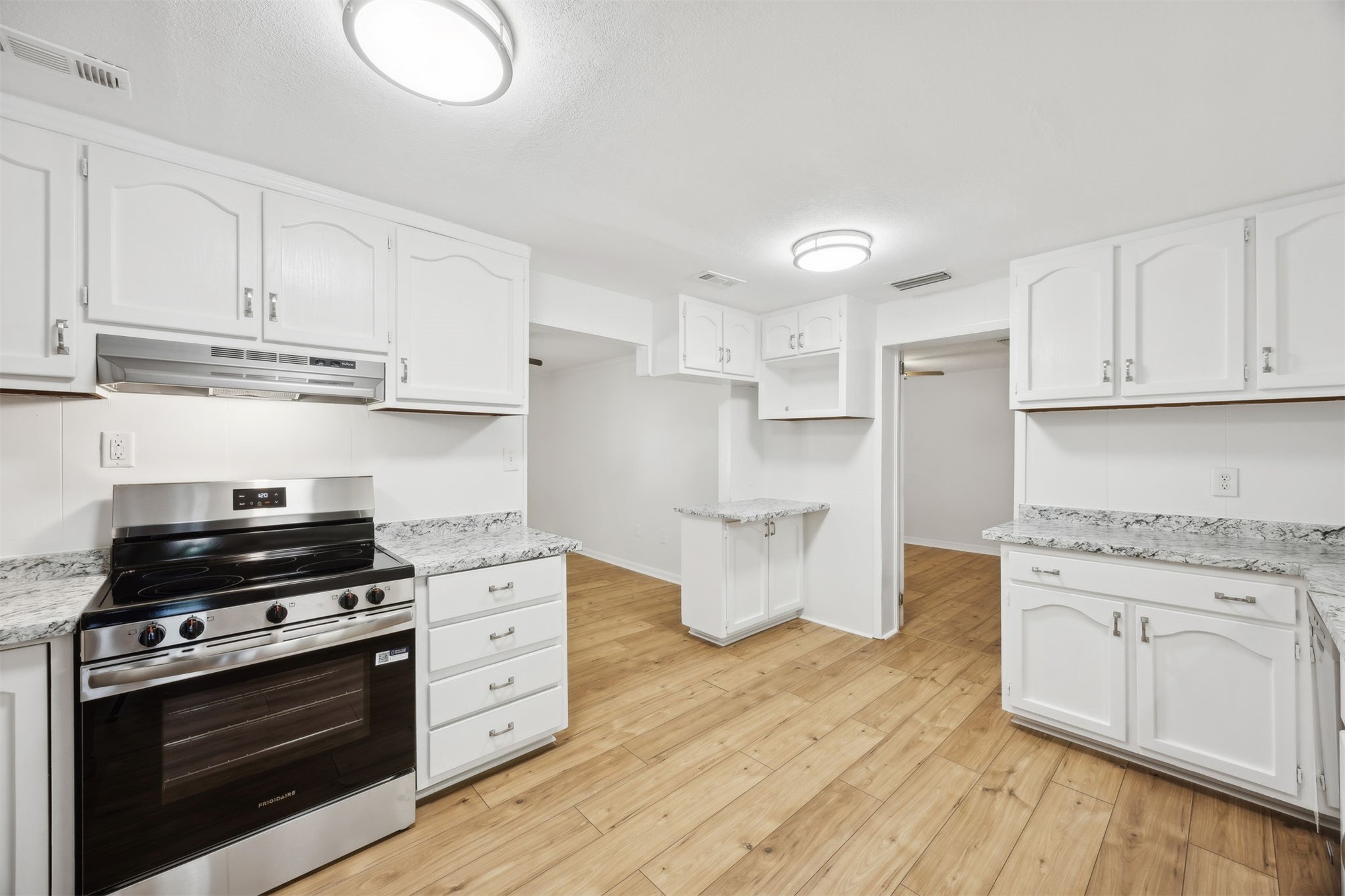 44186 Lee Drive Callahan, FL 32011 - Photo 5 of 29 a kitchen with stainless steel appliances a stove a sink and cabinets