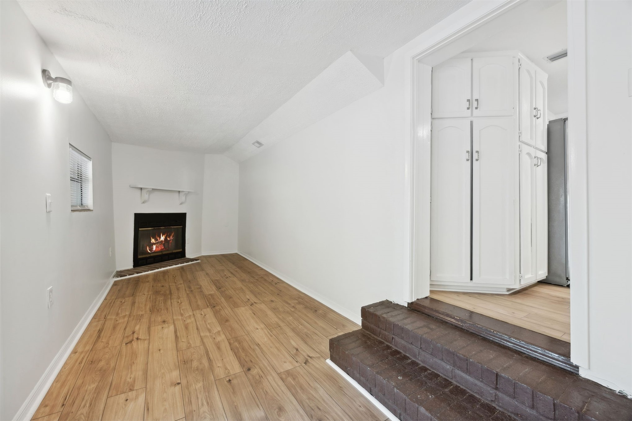 44186 Lee Drive Callahan, FL 32011 - Photo 8 of 29 a view of a livingroom with wooden floor and a fireplace
