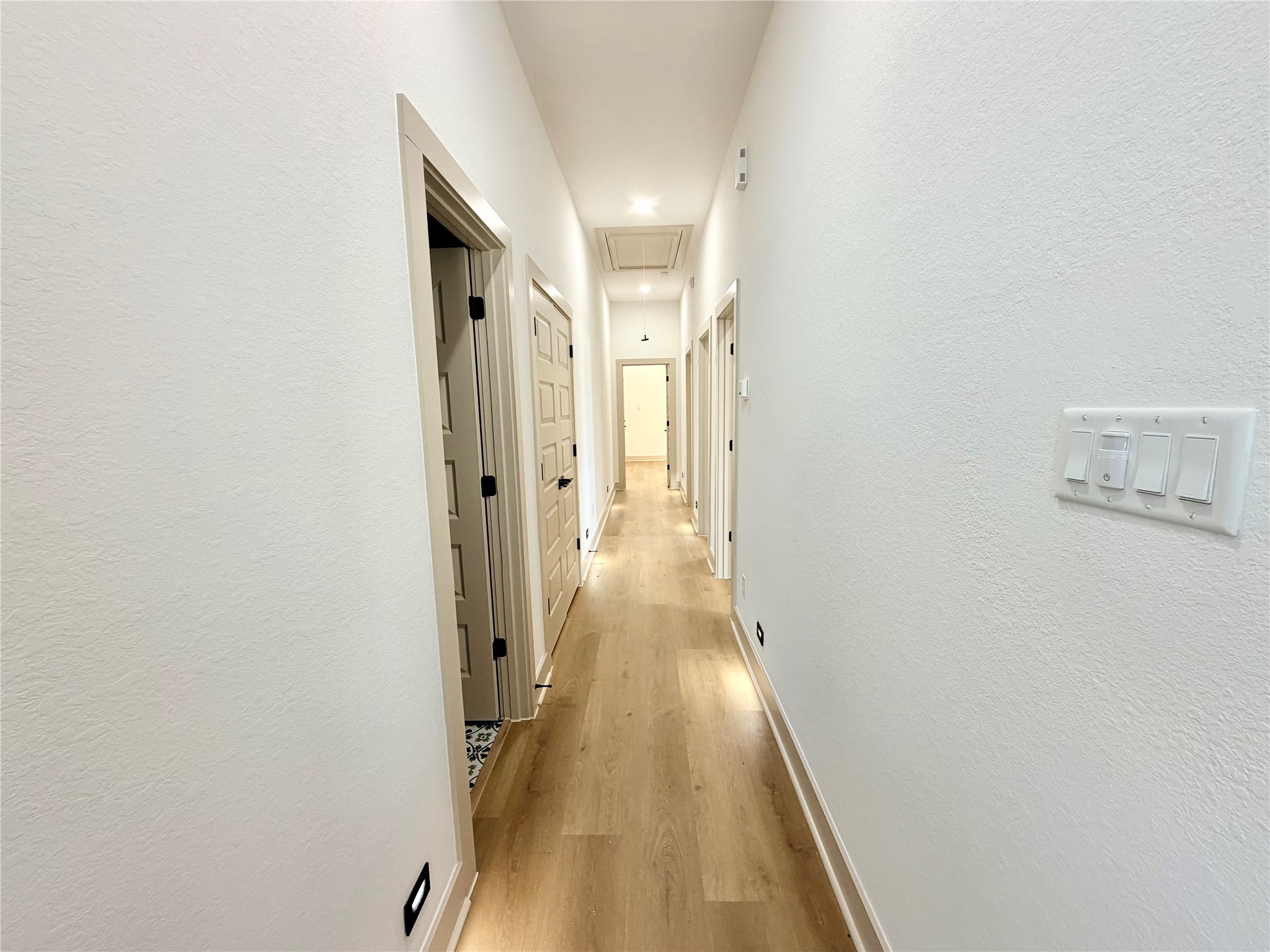 4214 Clover Street Houston, TX 77051 - Photo 15 of 34 a view of a hallway with wooden floor and a bathroom