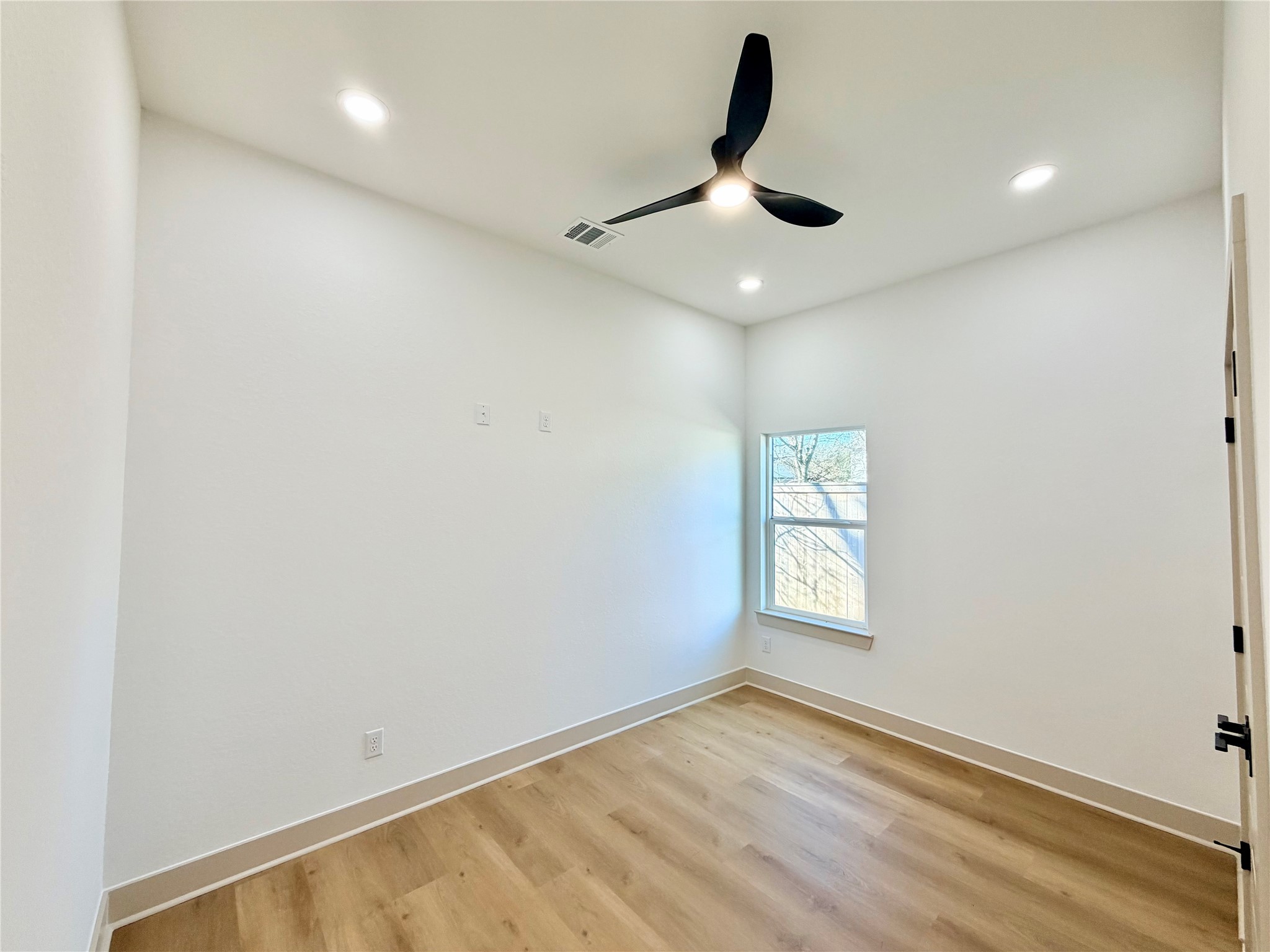 4214 Clover Street Houston, TX 77051 - Photo 23 of 34 an empty room with a window and ceiling fan