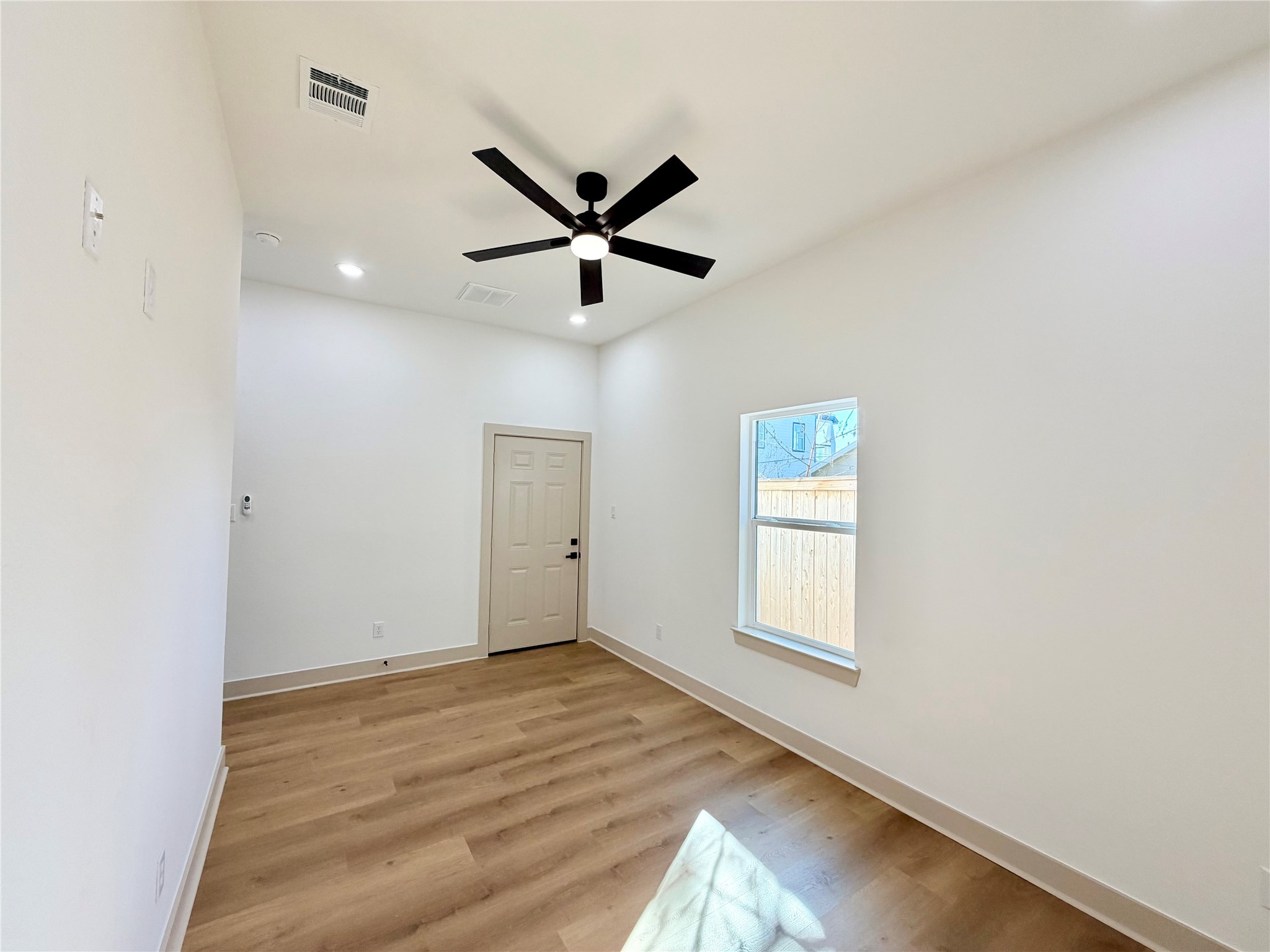 4214 Clover Street Houston, TX 77051 - Photo 25 of 34 a view of empty room with wooden floor and fan