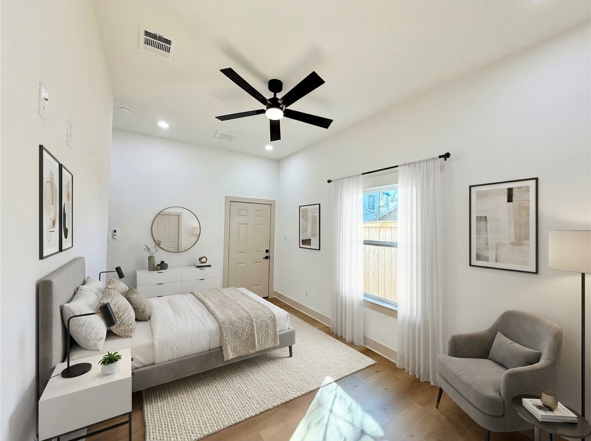 4214 Clover Street Houston, TX 77051 - Photo 26 of 34 a bedroom with a bed and wooden floor